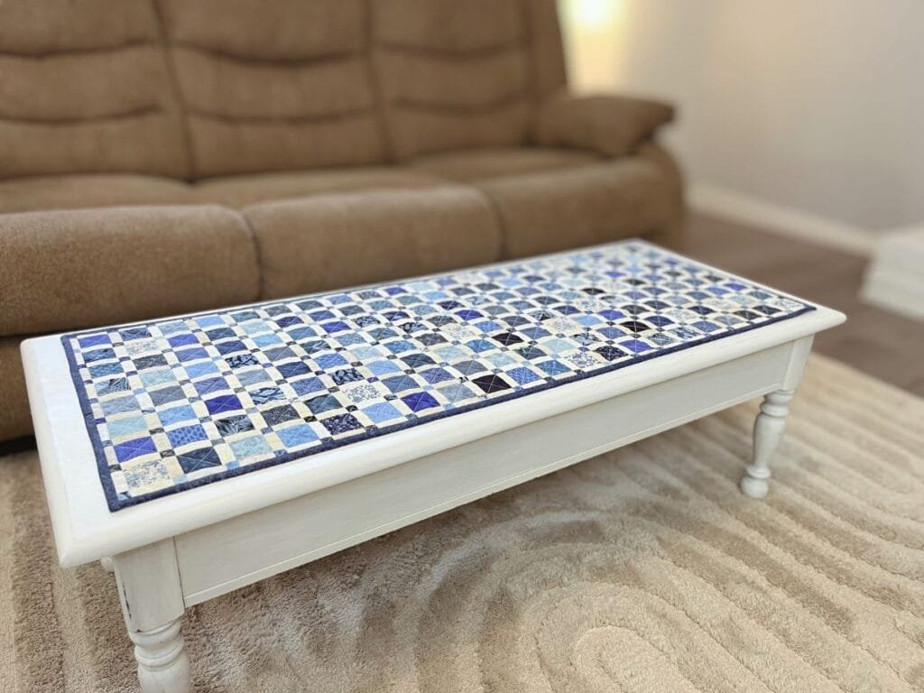 Finished quilted table runner with neatly sewn binding.