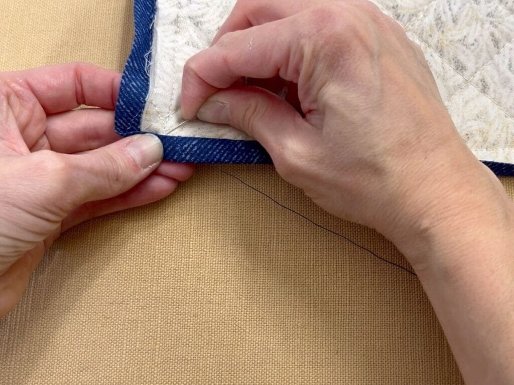 Hand-stitching binding to the back of a table runner for a clean finish