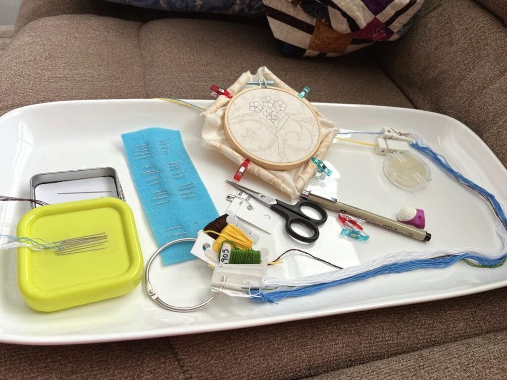 Supplies laid out in a tray. All ready to stitch on the couch.