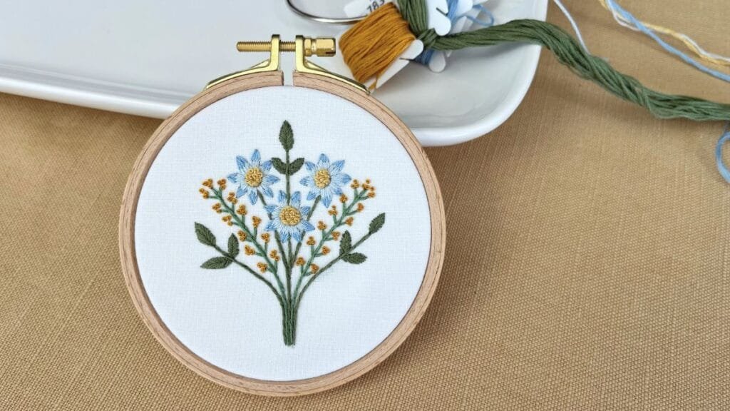 Yellow and blue floral hand embroidery design.