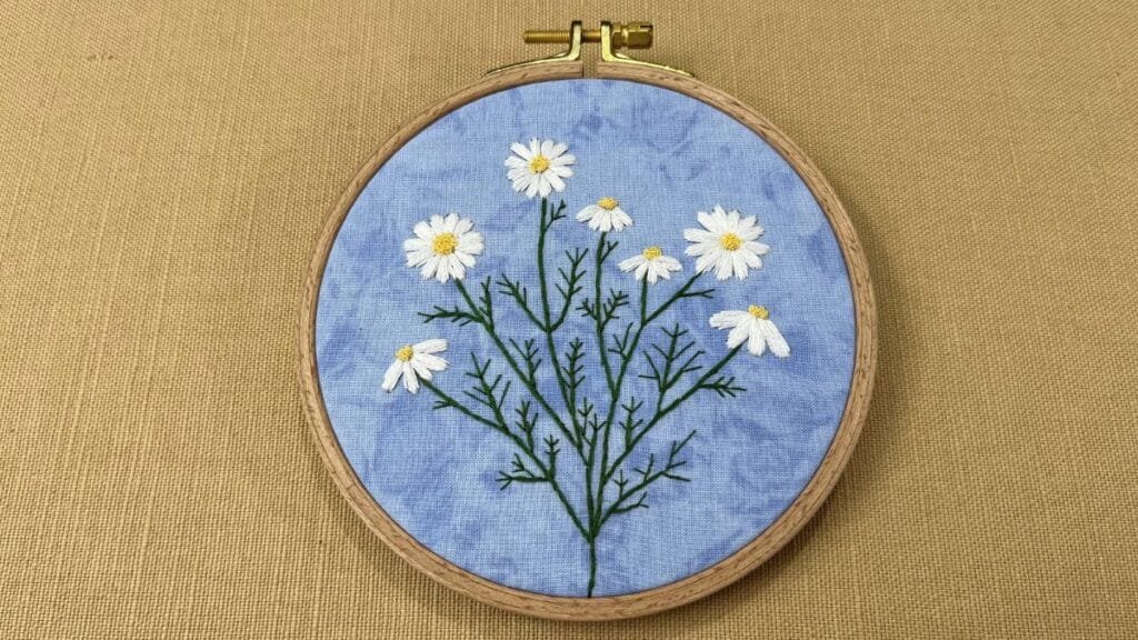 Wild daisy hand embroidery in a hoop.